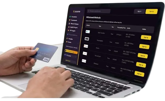 Laptop displaying Zoome casino withdrawal methods while a user holds a credit card.